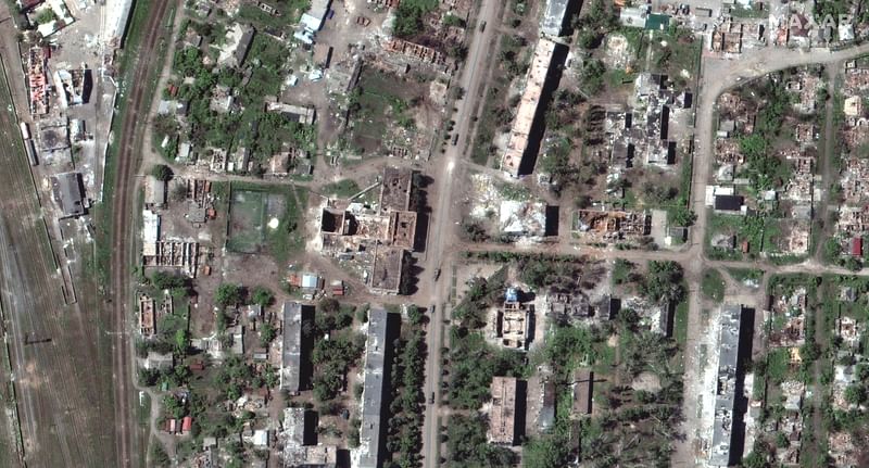 A satellite image shows destroyed buildings downtown and vehicles in convoy, in Popasna, Ukraine on 25 May 2022