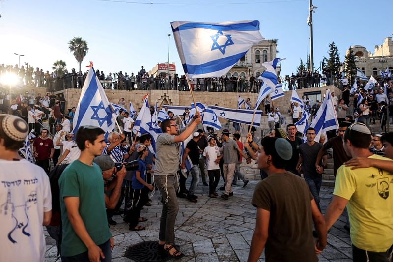 Israelis dance with flags by Damascus gate just outside Jerusalem's Old City on 15 June, 2021.