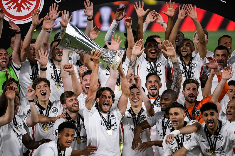 Eintracht Frankfurt's players celebrate with the trophy after winning the UEFA Europa League final football match between Eintracht Frankfurt and Glasgow Rangers at the Ramon Sanchez Pizjuan stadium in Seville on 18 May, 2022