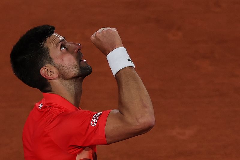 Serbia's Novak Djokovic reacts after winning against Japan's Yoshihito Nishioka at the end of their their men's singles match on day two of the Roland-Garros Open tennis tournament at the Court Philippe-Chatrier in Paris on 23 May, 2022