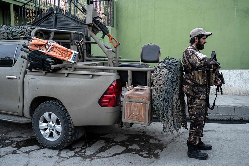 A Taliban fighter stands guard near the site of a blast in Kabul on 29 April, 2022