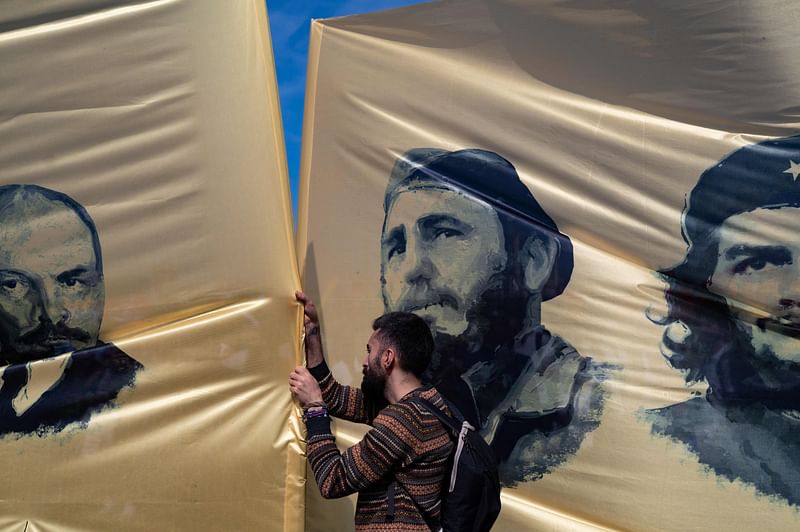 Demonstrators hold flags with the portraits of Cuban late leader Fidel Castro and late Argentinian revolutionary Che Guevara during the annual May Day (Labour Day) demonstration marking the international day of the workers in the Maltepe district of Istanbul, on 1 May, 2022