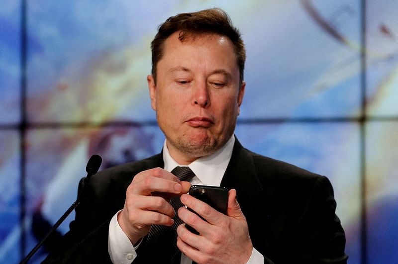 Elon Musk looks at his mobile phone in Cape Canaveral, Florida, US on 19 January 2020