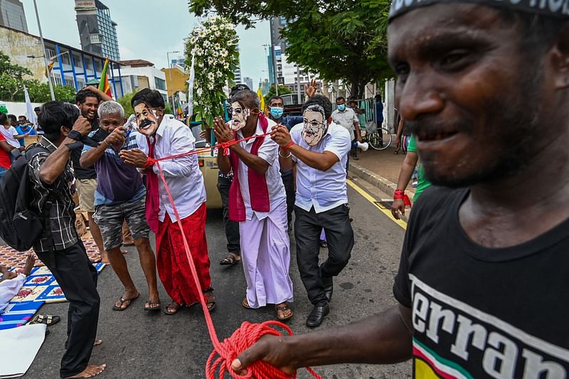 Protesters take part in a demonstration over the country's crippling economic crisis outside the official residence of Sri Lanka's prime minister in Colombo on 1 May 2022.