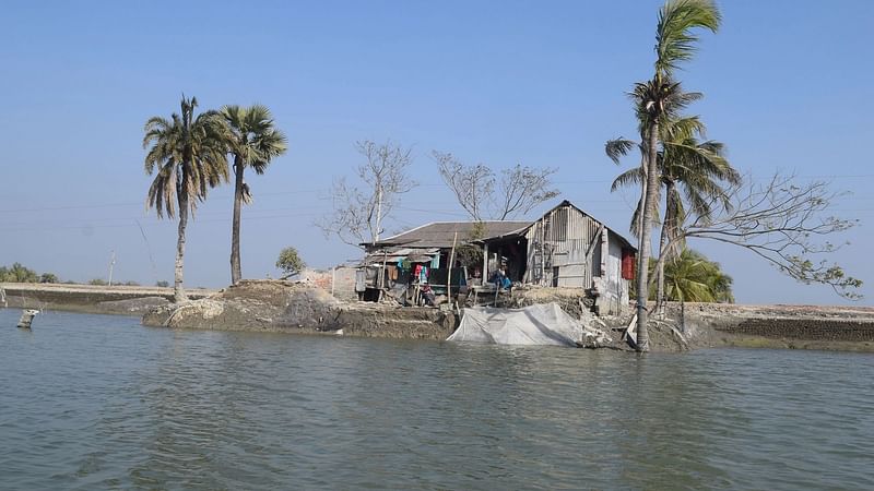 Mubarak Hossain's home in North Bedkashi village, in southern Bangladesh, was left isolated on an island after flooding driven by Cyclone Amphan, on 30 April 2021