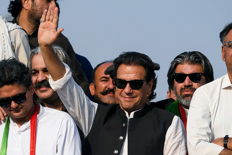 Ousted Pakistan's prime minister Imran Khan (C) waves at his party supporters during a rally in Islamabad on 26 May, 2022