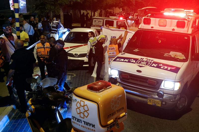 Israeli police and paramedics are seen at the scene of an attack in the central city of Elad, on 5 May, 2022