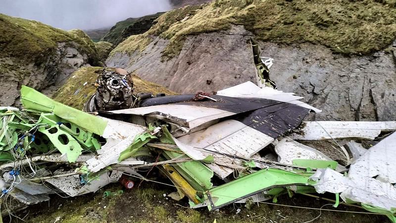 This handout photograph taken on 30 May 2022 and released by the Nepal Police shows the wreckage of a Twin Otter aircraft, operated by Nepali carrier Tara Air, laying on a mountainside in Mustang, a day after it crashed. Nepali rescuers on 30 May retrieved 16 bodies from the mangled wreckage of a passenger plane strewn across a mountainside that crashed in the Himalayas with 22 people on board.