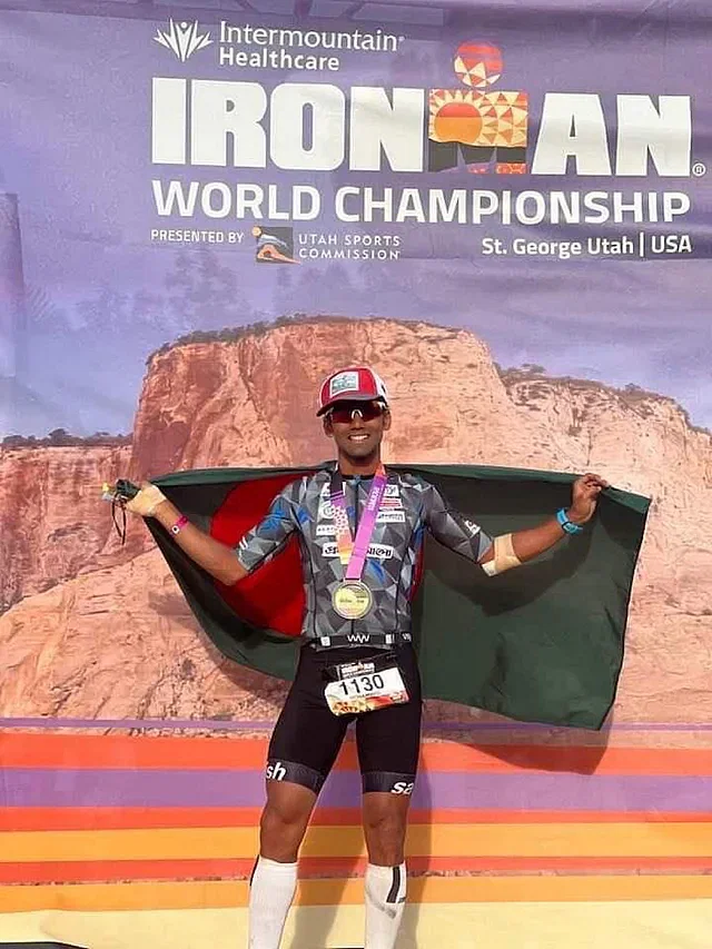 Bangladeshi triathlete Mohammad Shamsuzzaman Arafat poses with the Bangladesh flag after completing the Ironman World Championship race.