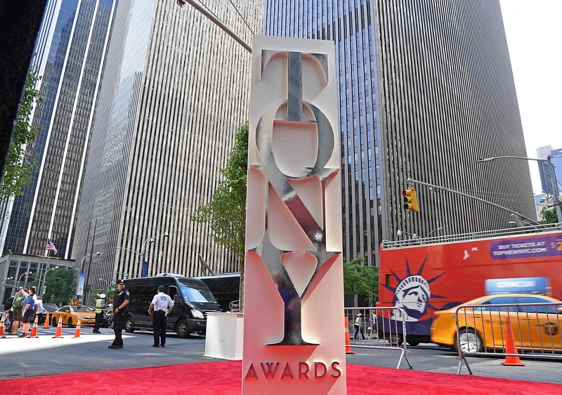 In this file photo taken on 11 June, 2017, cars drive past the entrance to the 2017 Tony Awards-Red Carpet at Radio City Music Hall in New York City. A new Pulitzer Prize-winning musical about a young artist's inner demons is leading this year's Tony nominations announced on 9 May, 2022, with 11 chances at the highest honors in American theater.