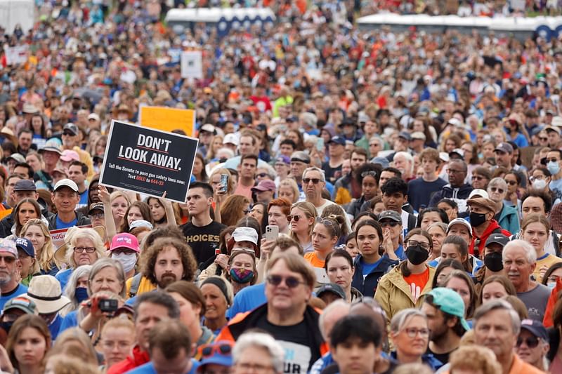 People participate in the March for Our Lives, one of a series of nationwide protests against gun violence, on the National Mall in Washington, DC, U.S., 11 June 2022.