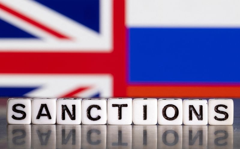 Plastic letters arranged to read "Sanctions" are placed in front the Union Jack and Russian flag colors in this illustration taken February 28, 2022.