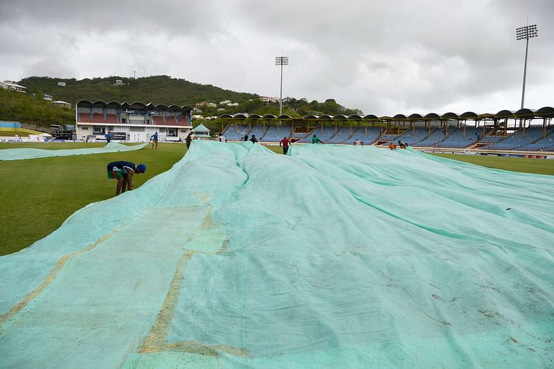 Ground staff pull covers onto the field during the third day of the 2nd Test between Bangladesh and West Indies at Darren Sammy Cricket Ground in Gros Islet, Saint Lucia, on 26 June, 2022