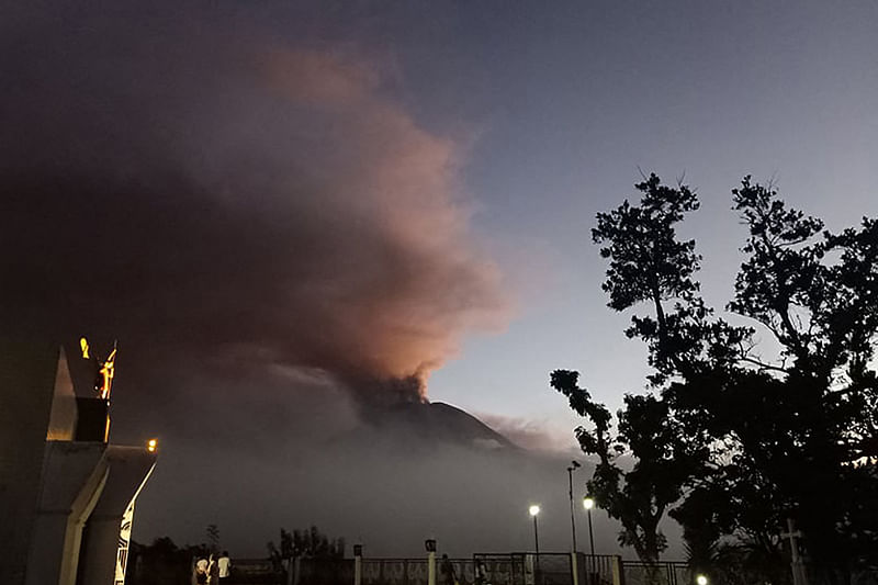 This handout photo taken on 12 June, 2022 and received courtesy of Mylene Ganton Sierra shows Bulusan volcano spewing ash as seen from Irosin town, Sorsogon province, south of Manila