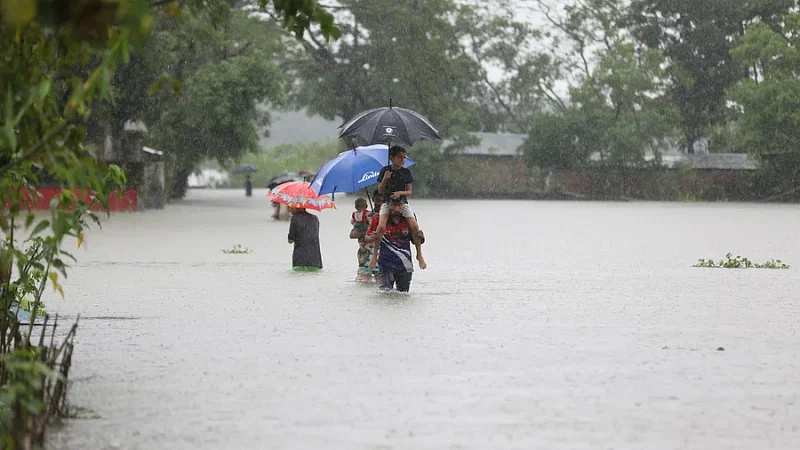 Homesteads were inundated in flood water and people rushed to the shelters. The photo was taken from Salutikor area of Goainghat of Sylhet.