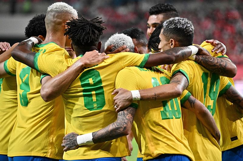 Brazil's forward Neymar (C) celebrates with teammates after he scored a penalty goal during the international football friendly match between South Korea and Brazil at Seoul World Cup Stadium in Seoul on 2 June 2022.