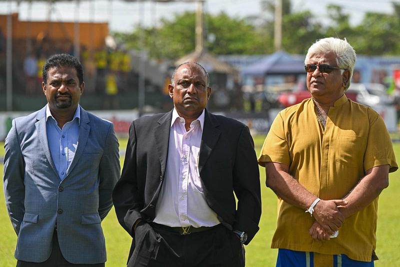 Sri Lanka's cricket legends Muttiah Muralitharan (L), Aravinda de Silva (C) and Arjuna Ranatunga pose for pictures during the first day play of the first cricket Test match between Sri Lanka and Australia at the Galle International Cricket Stadium in Galle on 29 June, 2022