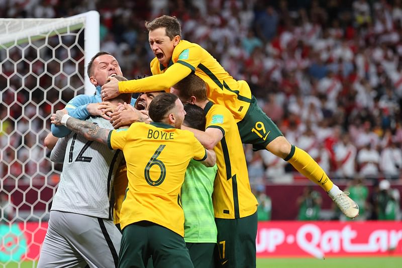 Australia's players celebrate winning the FIFA World Cup 2022 inter-confederation play-offs match between Australia and Peru on June 13, 2022, at the Ahmed bin Ali Stadium in Qatar