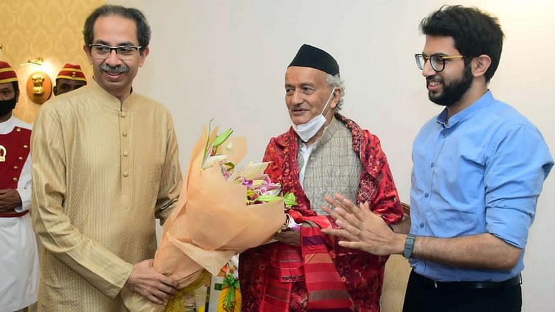 Maharashtra governor Bhagat Singh Koshyari (C) being greeted by state chief minister Uddhav Thackeray and his son Aaditya Thackeray with a bouquet on his 80th birthday, at Raj Bhavan, in Mumbai on 18 June 2022