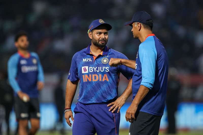 India's head coach Rahul Dravid (R) speaks with Rishabh Pant (C) before the start of the third Twenty20 international cricket match between India and South Africa at the YS Rajasekhara Reddy International Cricket Stadium in Visakhapatnam on 14 June, 2022