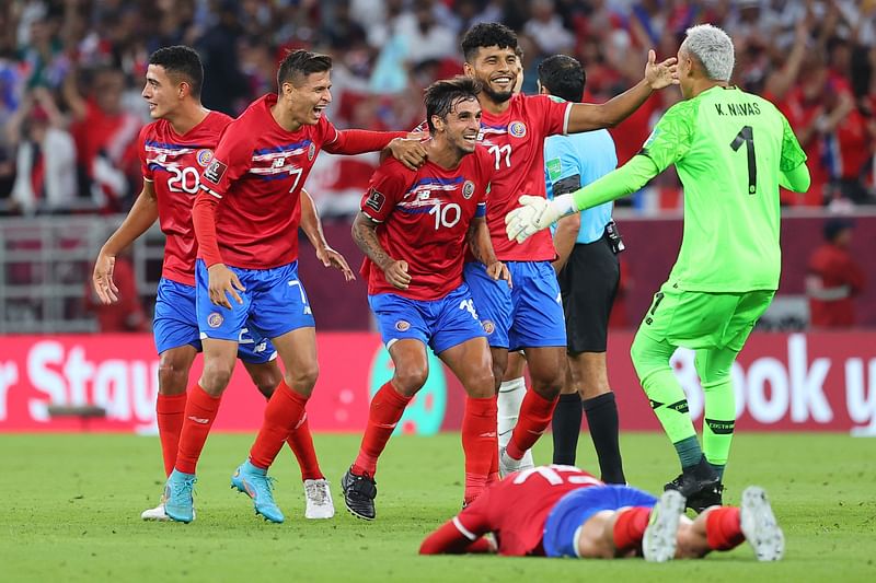 Costa Rica's players celebrate their win in the FIFA World Cup 2022 inter-confederation play-offs match between Costa Rica and New Zealand on 14 June, 2022