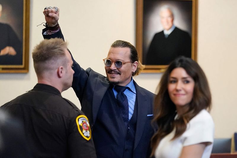 In this file photo taken on May 27, 2022, US actor Johnny Depp gestures to spectators in court after closing arguments at the Fairfax County Circuit Courthouse in Fairfax, Virginia. A US jury found 1 June, 2022