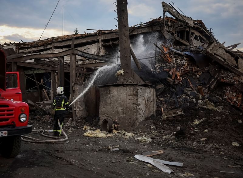 A man rides a bicycle in front of buildings destroyed by Russian military strike, amid Russia's invasion on Ukraine, are seen in the town of Dobropillia, in Donetsk region, Ukraine 14 June, 2022