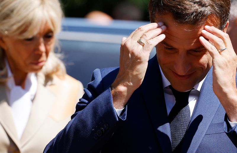 France's President Emmanuel Macron and his wife French first lady Brigitte Macron arrive to vote in French parliamentary elections at a polling station in Le Touquet, northern France on 12 June, 2022