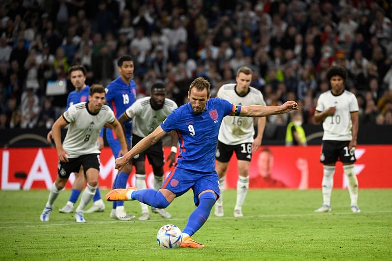 England's forward Harry Kane shoots from the penalty spot to score his team's equaliser during the UEFA Nations League football match Germany v England in Munich, southern Germany on 7 June, 2022