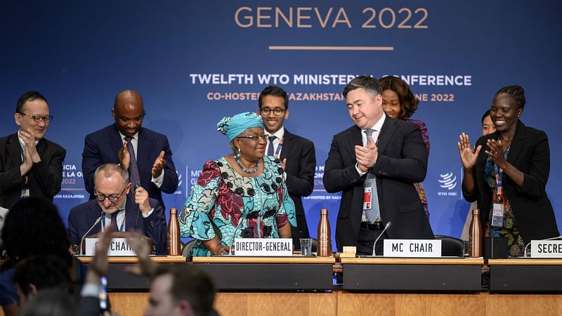 World Trade Organization Director-General Ngozi Okonjo-Iweala (C-L) applauds next to conference chair Timur Suleimenov (2nd R) after a closing session of a World Trade Organization Ministerial Conference at the WTO headquarters in Geneva on early 17 June, 2022