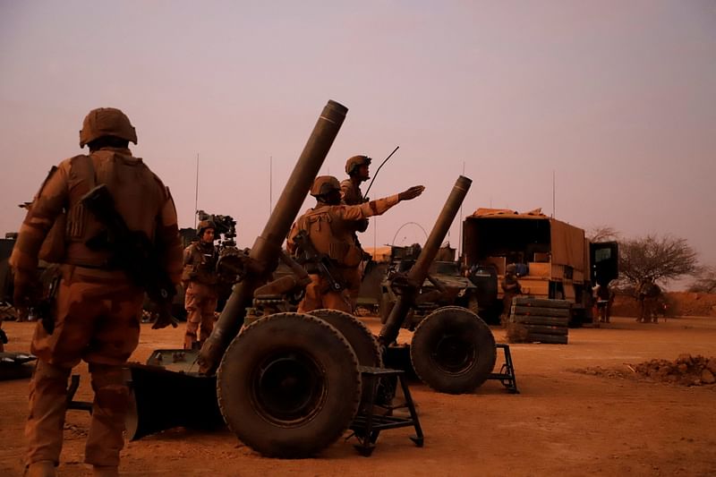 French soldiers from Operation Barkhane, prepare to fire mortars with flare shells on a temporary advanced operating base, as they leave Gossi, Mali, on 17 April, 2022