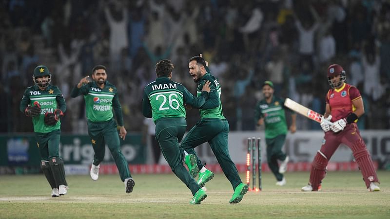 Pakistan’s Mohammad Nawaz (C) celebrates with teammates after taking the wicket of West Indies’ Brandon King (R) during the second one-day international (ODI) cricket match between Pakistan and West Indies at the Multan Cricket Stadium in Multan on 10 June, 2022