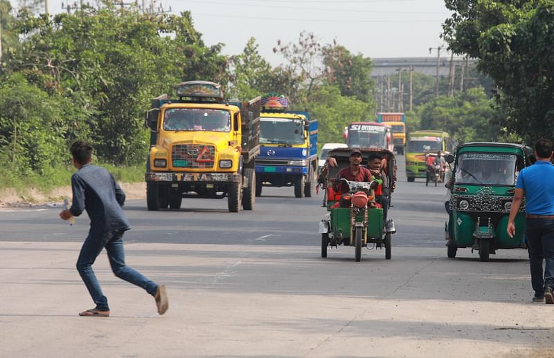 A man crosses raod, risking his life while three-wheelers move on Dhaka-Chattagram highway in Shitalpur area of Chattogram on 13 June 2022, posing risk of road accident