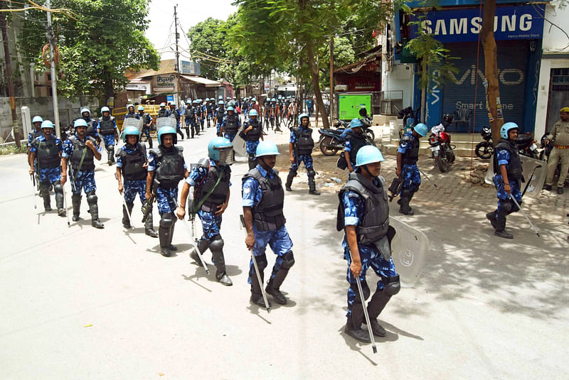 Rapid Action Force (RAF) personnel patrol the street during a curfew imposed after a protest against suspended BJP leader Nupur Sharma and expelled party leader Naveen Jindal over their alleged remarks on Prophet Muhammad, in Prayagraj on Saturday.