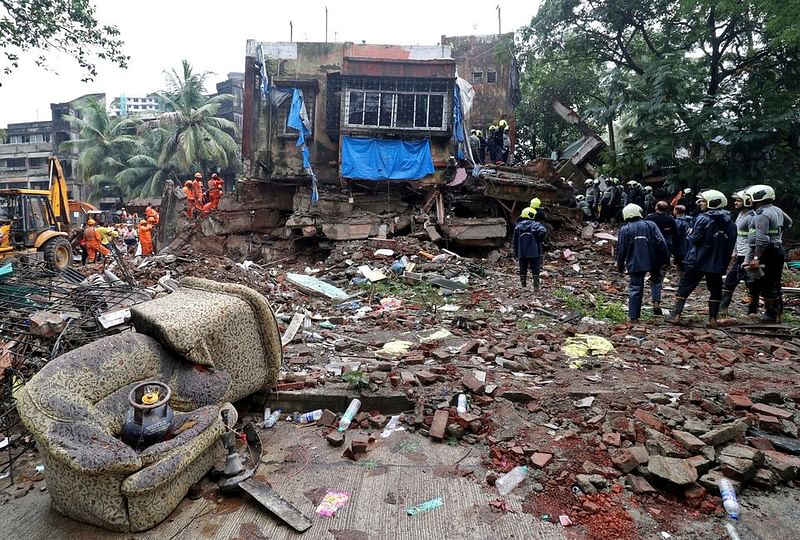 Rescue workers and firefighters search for survivors at the site of a collapsed residential building in Mumbai, India, on June 28, 2022.