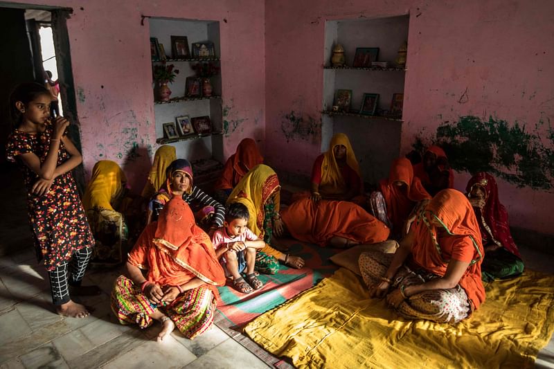 Supyar Devi (C, laying on ground) mourns for her three married daughters and two grandchildren, who were found dead in a well in Dudu village on May 28, at the family home in Chhapya village of India's Rajasthan state on 31 May, 2022