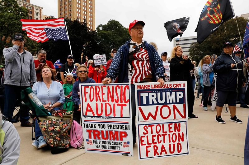 In this file photo taken on October 12, 2021 Protesters call for a "forensic audit" of the 2020 presidential election, during a demonstration by a group called Election Integrity Fund and Force outside of the Michigan State Capitol , in Lansing. A new movie that pushes dubious and widely debunked conspiracy theories to bolster Donald Trump's claim that he was robbed of a second term as president has become a surprise hit at the US box office