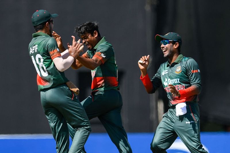 Taijul Islam (2L) and Mehidy Hasan Miraz (R) of Bangladesh celebrate the dismissal of Brandon King of West Indies during the 3rd and final ODI match between West Indies and Bangladesh at Guyana National Stadium in Providence, Guyana, on 16 July, 2022