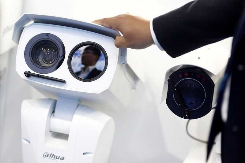 A man adjusts a CCTV camera at the stall of the video surveillance product maker Dahua Technology  in 2018.