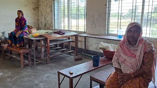 Two women at Companiganj Thana Sadar Govt Model High School flood shelter centre on the Eid day