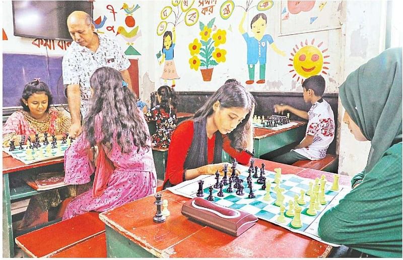 Polly Khatun (in red) and others playing chess at the Sohag Swapnadhara Pathshala in Duaripur, Mirpur