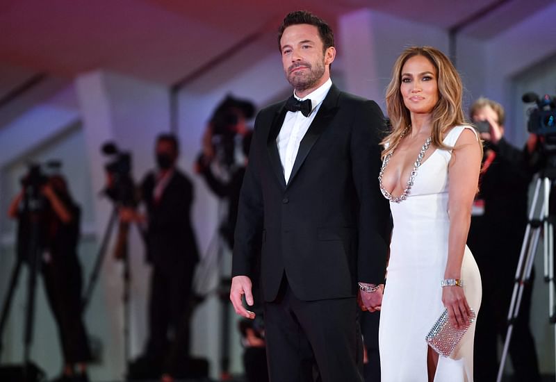 In this file photo taken on 10 September, 2021, US actor Ben Affleck and US actress and singer Jennifer Lopez arrive for the screening of the film "The Last Duel" presented out of competition during the 78th Venice Film Festival at Venice Lido