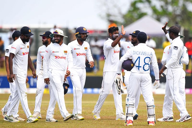 Sri Lanka's players walk back to the pavilion at the end of the Pakistan first inning during the third day of the second cricket Test match between Sri Lanka and Pakistan at the Galle International Cricket Stadium in Galle on 26 July, 2022