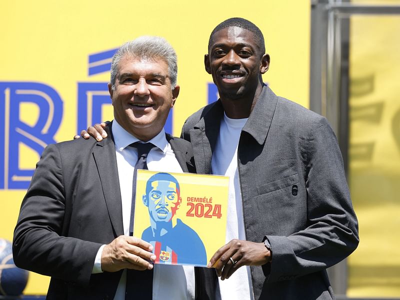 FC Barcelona president Joan Laporta and Ousmane Dembele pose for a picture during the contract renewal at the Ciutat Esportiva Joan Gamper, Barcelona, Spain on July 14, 2022