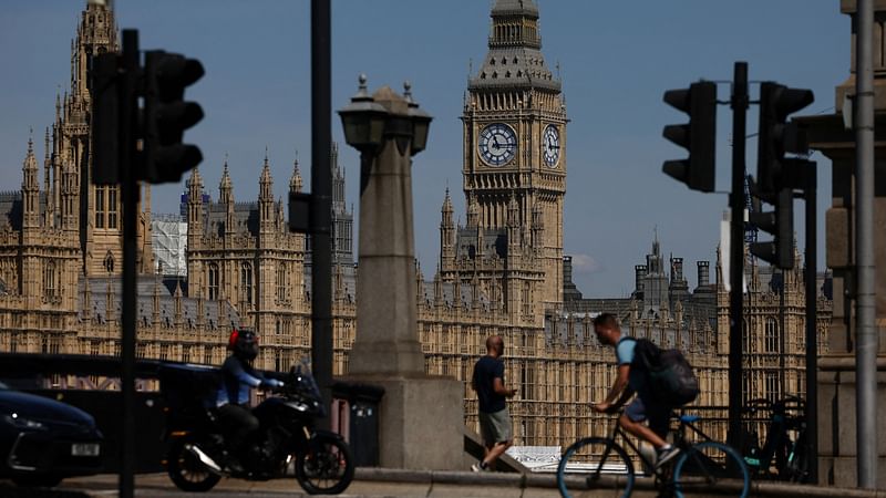 People walk near to the Houses of Parliament in London, Britain, on 11 July 2022