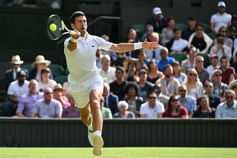 Serbia's Novak Djokovic returns the ball to Serbia's Miomir Kecmanovic during their men's singles tennis match on the fifth day of the 2022 Wimbledon Championships at The All England Tennis Club in Wimbledon, southwest London, on 1 July, 2022.