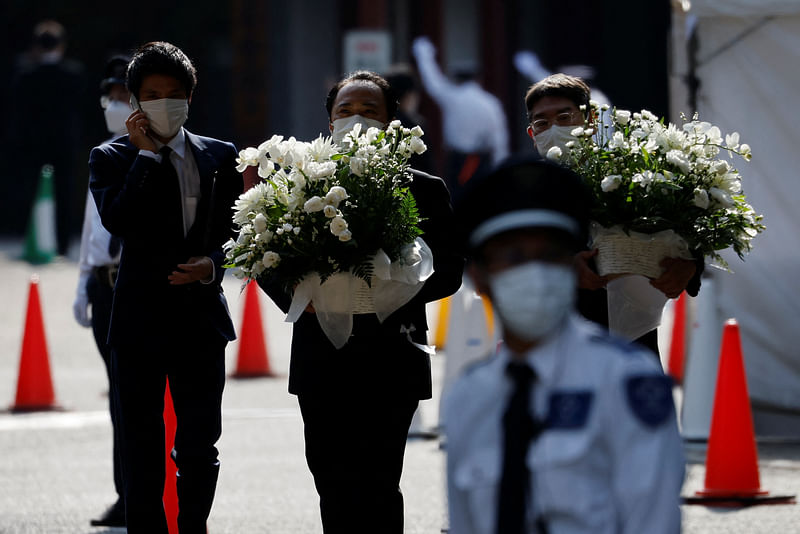 Officials carry flowers inside Zojoji Temple, where the vigil and funeral of late former Japanese Prime Minister Shinzo Abe, who was shot while campaigning for a parliamentary election, was held in Tokyo, Japan on 11 July, 2022.