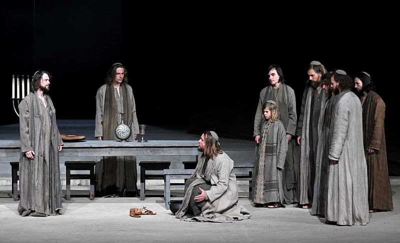 This file photo taken on 4 May, 2022 shows German actor Frederik Mayet as Jesus (C) and ensemble members performing during a rehearsal at Oberammergau's Passion Play theatre in Oberammergau, southern Germany