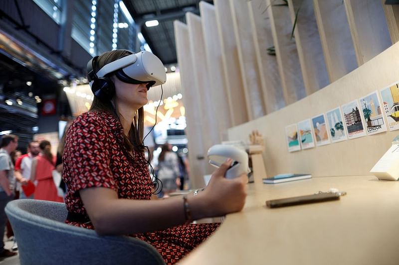 An attendee wearing a virtual reality (VR) headset tries out a VR application on the Meta Platforms Inc. booth at the Viva Technology conference dedicated to innovation and startups at Porte de Versailles exhibition center in Paris, France June 16, 2022.