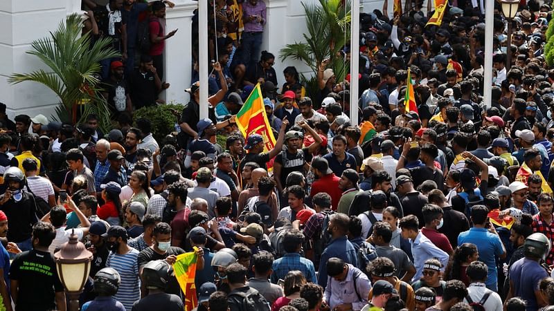 Demonstrators gather on the lawn after some of them entered the building of the office of Sri Lanka's prime minister Ranil Wickremesinghe, amid the country's economic crisis, in Colombo, Sri Lanka 13 July 2022.